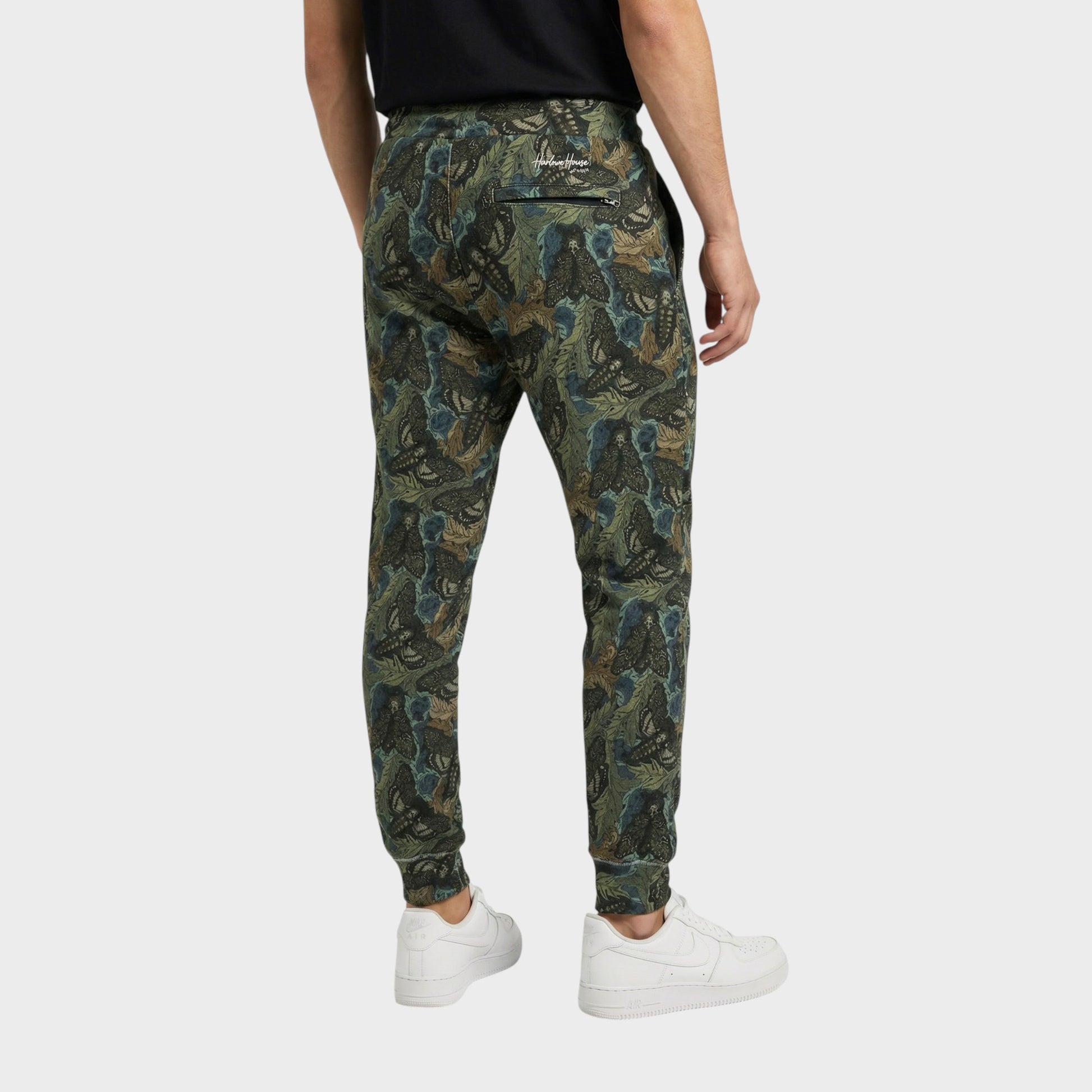 Tasoni men's green cotton sweatpants with a dark floral and moth print, elastic waist, and zippered back pocket.