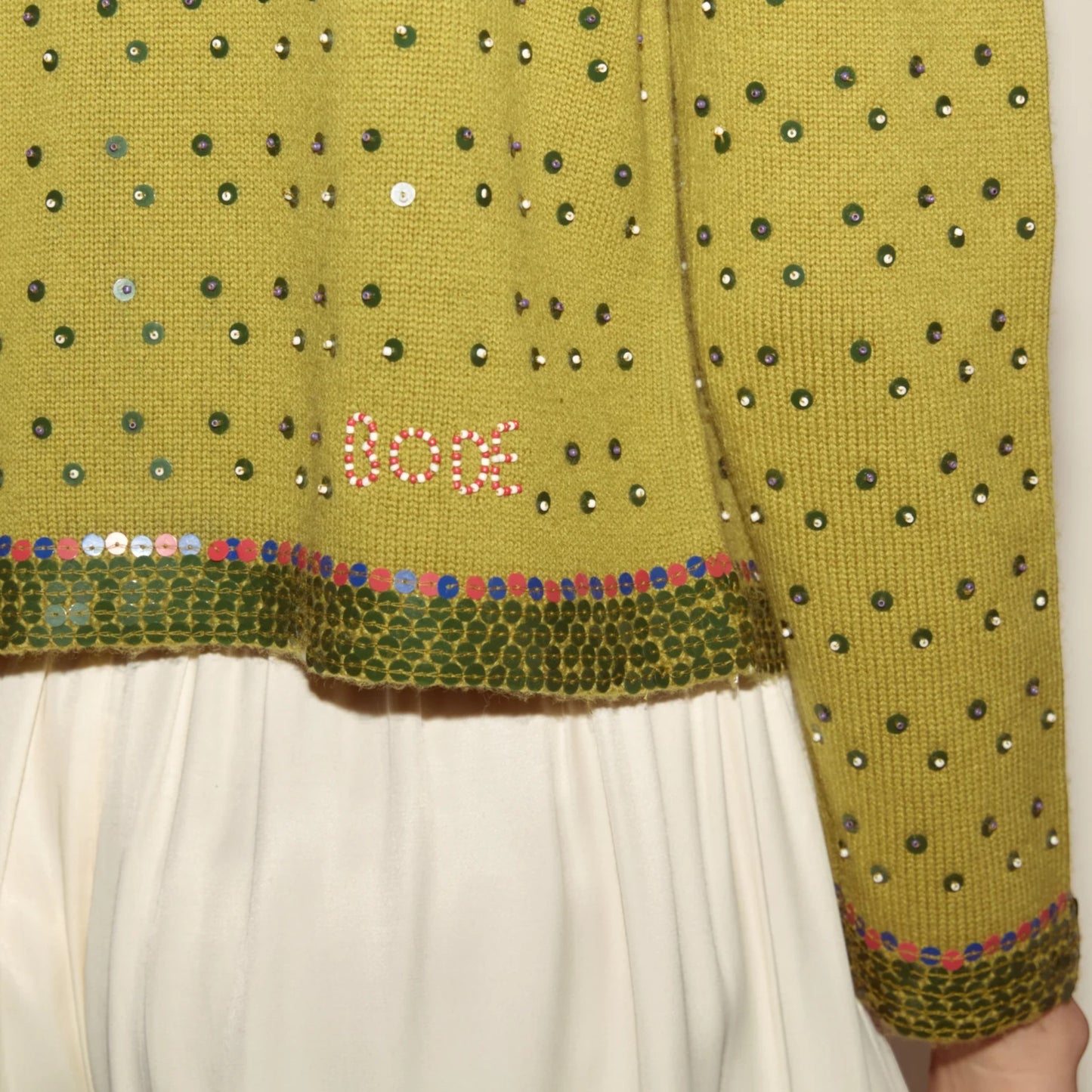 Tasoni green knit cardigan with fairy floss sequins and embroidered 'Bode' detail. Crew neck with sequined trim.
