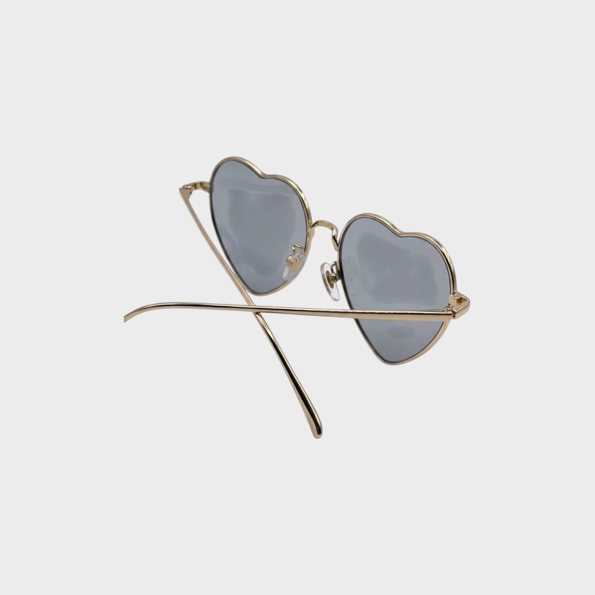 Tasoni gold-rimmed heart-shaped sunglasses with blue-tinted lenses.