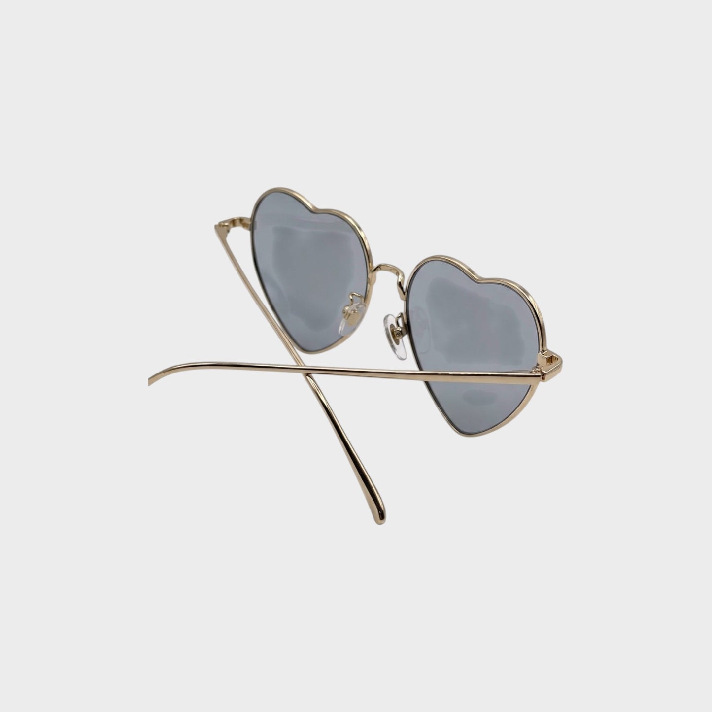Tasoni gold-rimmed heart-shaped sunglasses with blue-tinted lenses.
