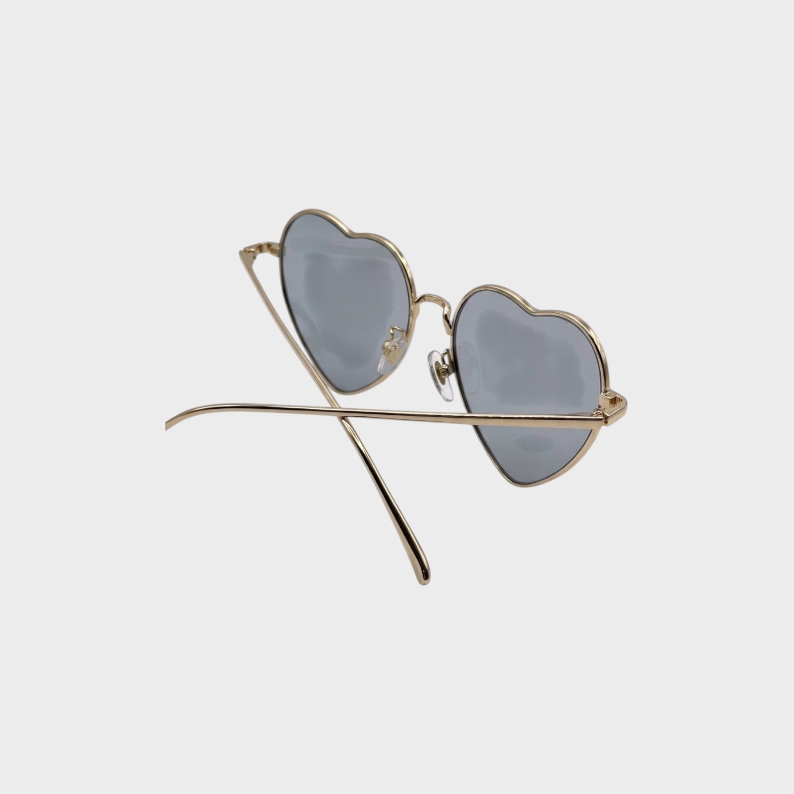 Tasoni gold-rimmed heart-shaped sunglasses with blue-tinted lenses.