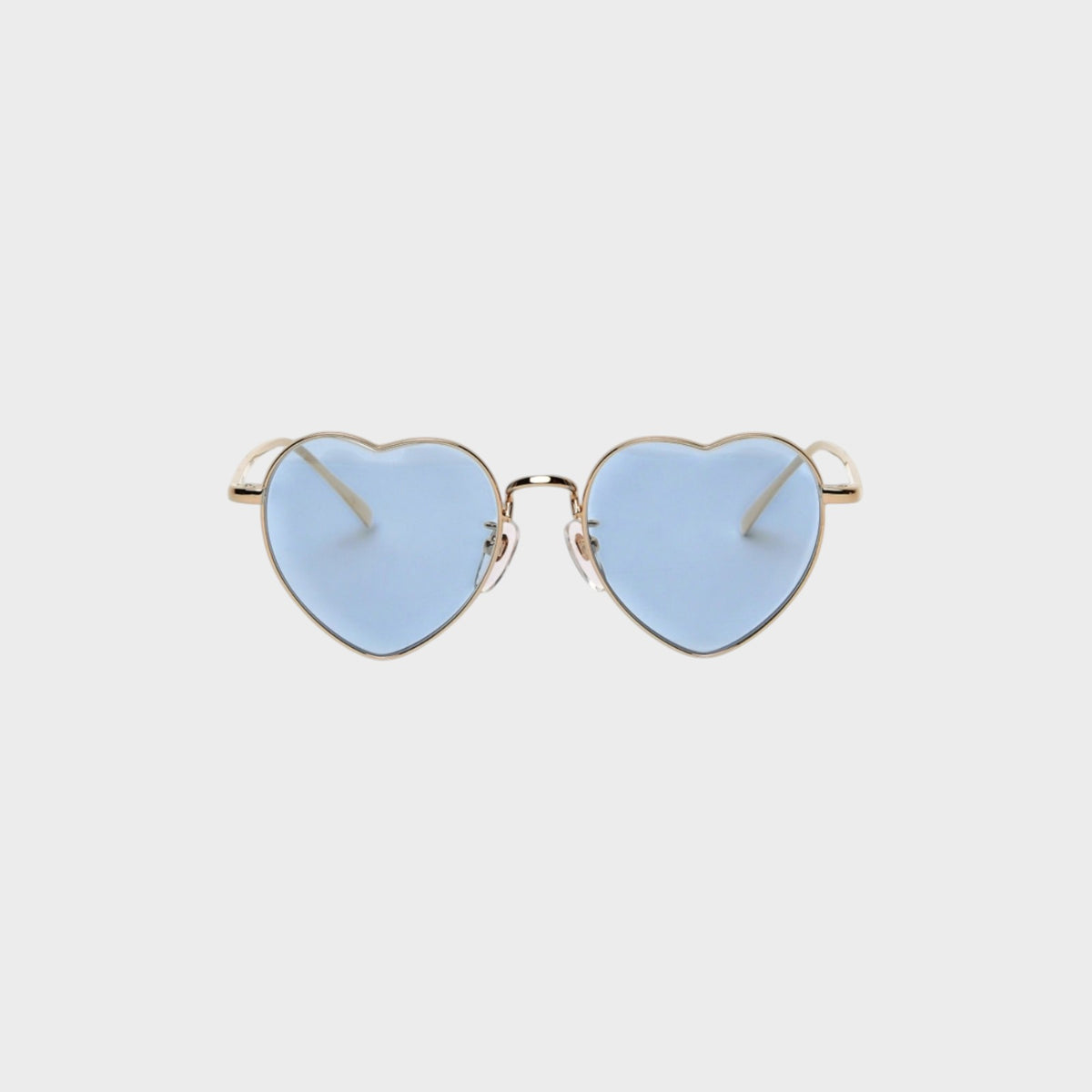 Tasoni heart-shaped sunglasses with gold frames and light blue lenses.