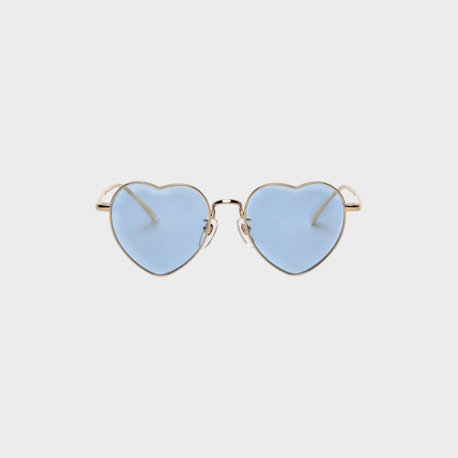Tasoni heart-shaped sunglasses with gold frames and light blue lenses.