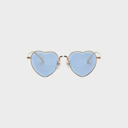 Tasoni heart-shaped sunglasses with gold frames and light blue lenses.