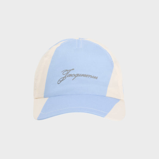 Tasoni blue and cream nylon baseball cap with diagonal stripes and embroidered logo.