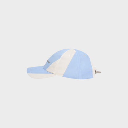 Tasoni blue and white striped nylon baseball cap with adjustable strap and logo detail.