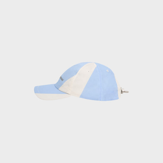 Tasoni blue and white striped nylon baseball cap with adjustable strap and logo detail.