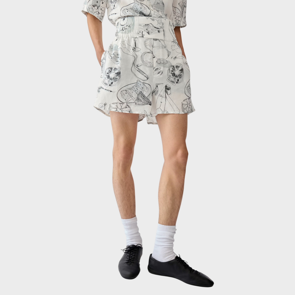 Tasoni Jacquemus Le Boxer Shorts in white with black line art illustrations, featuring a high-waisted elastic fit.