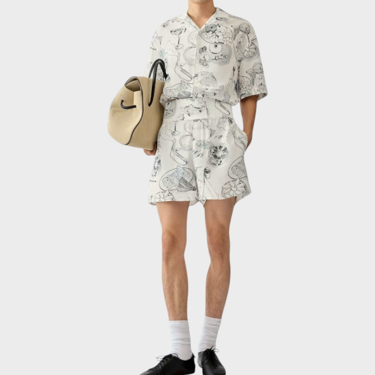 Tasoni Jacquemus Le Boxer Shorts in white with black line art illustrations, featuring a high-waisted relaxed fit.