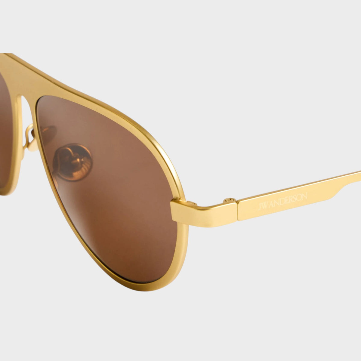 Tasoni JW Anderson Jwa05 gold titanium aviator sunglasses with brown tinted lenses and engraved temple detail.