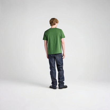Model wearing a green JW Anderson Embroidery T-Shirt from Tasoni with dark blue jeans against a white background.