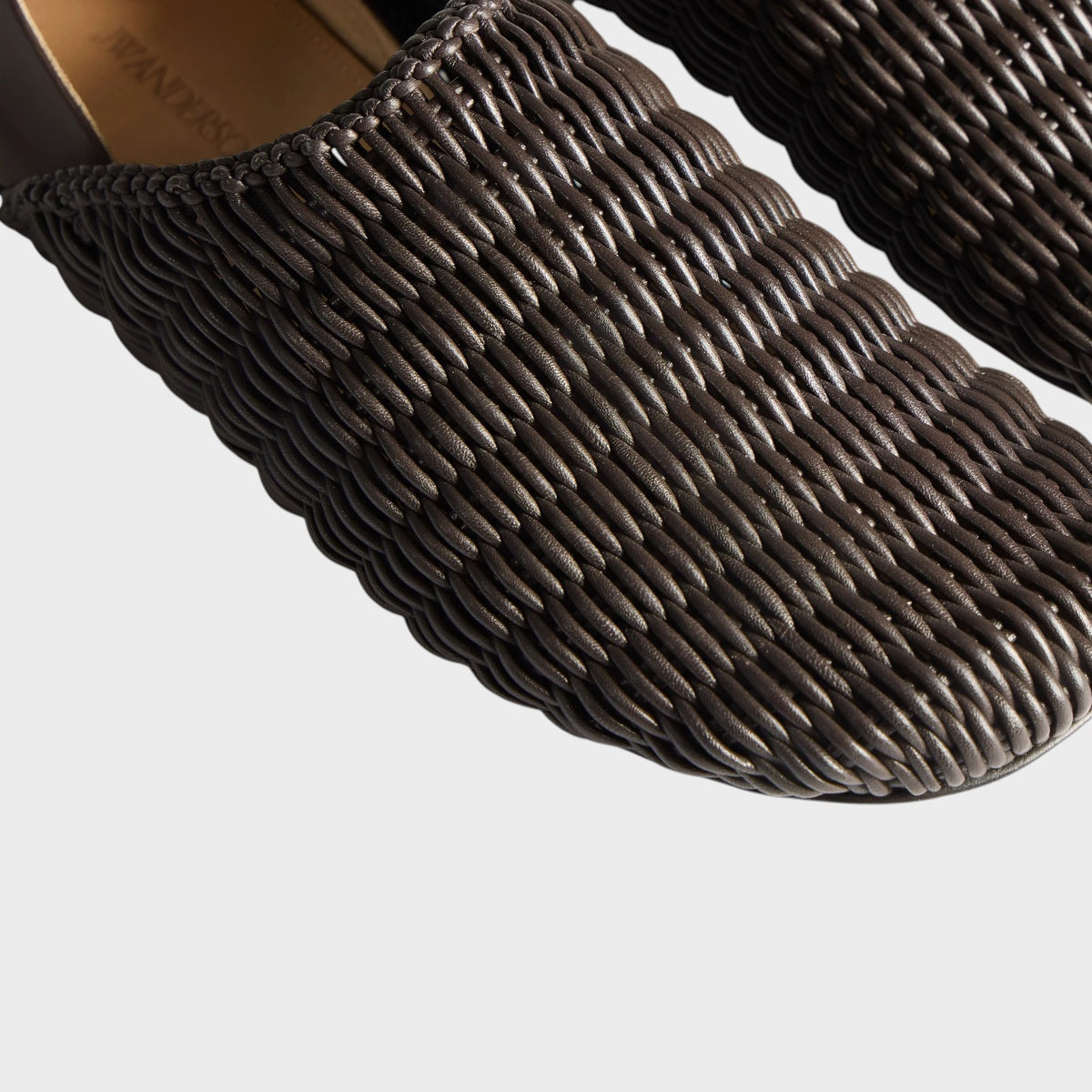Tasoni JW Anderson dark brown leather slipper mule featuring a textured woven upper design.