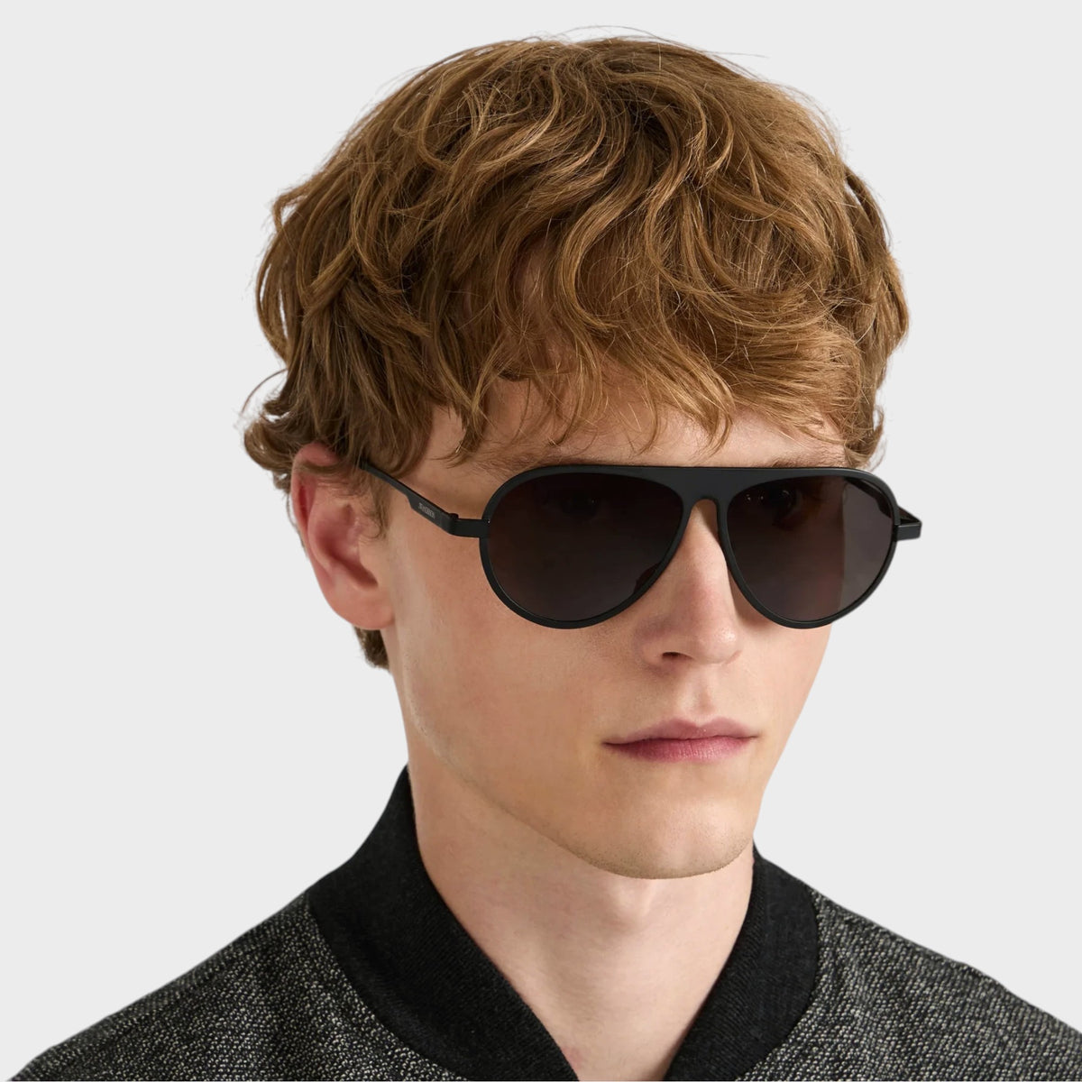 Tasoni model wearing black JW Anderson Jwa05 titanium aviator sunglasses with a sleek, modern design.