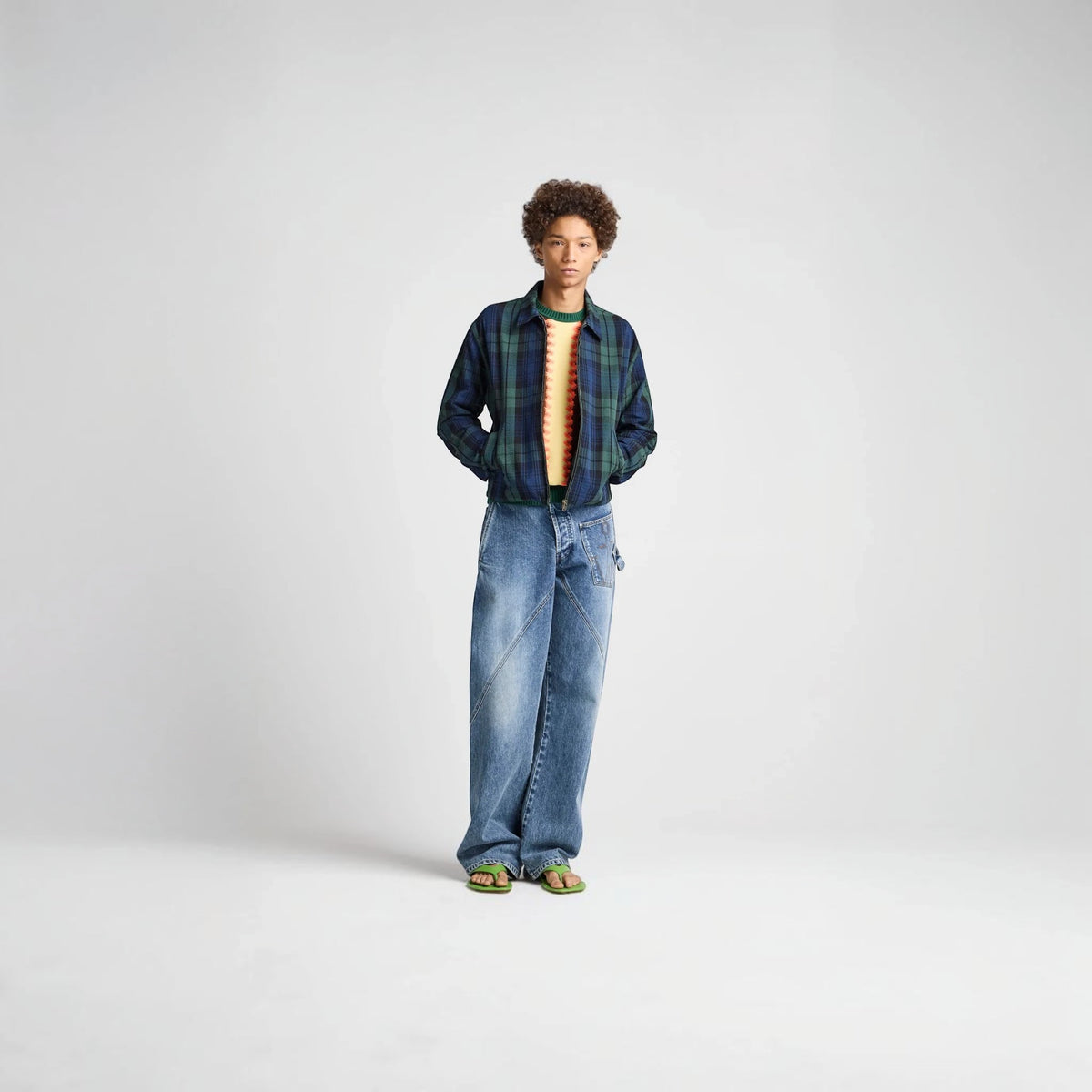 Model wearing a Tasoni J.W.Anderson navy and green cotton check print zip-up jacket with a collared neckline.