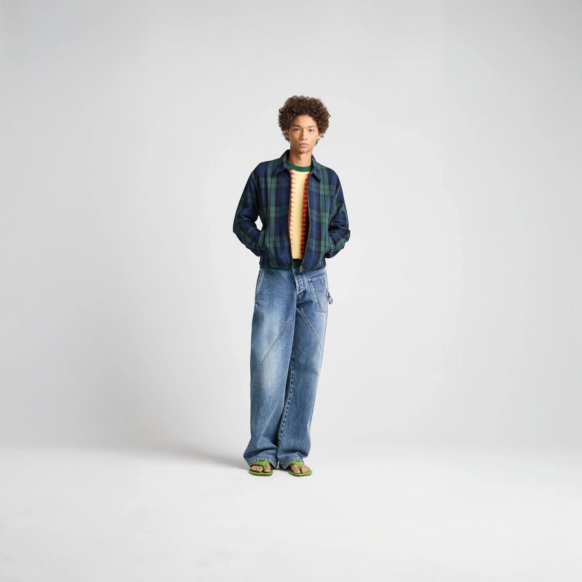 Model wearing a Tasoni J.W.Anderson navy and green cotton check print zip-up jacket with a collared neckline.