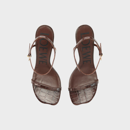 Tasoni Loewe Toy Croc 90mm Sandal Heels in dark brown patent leather with ankle strap and embossed logo.
