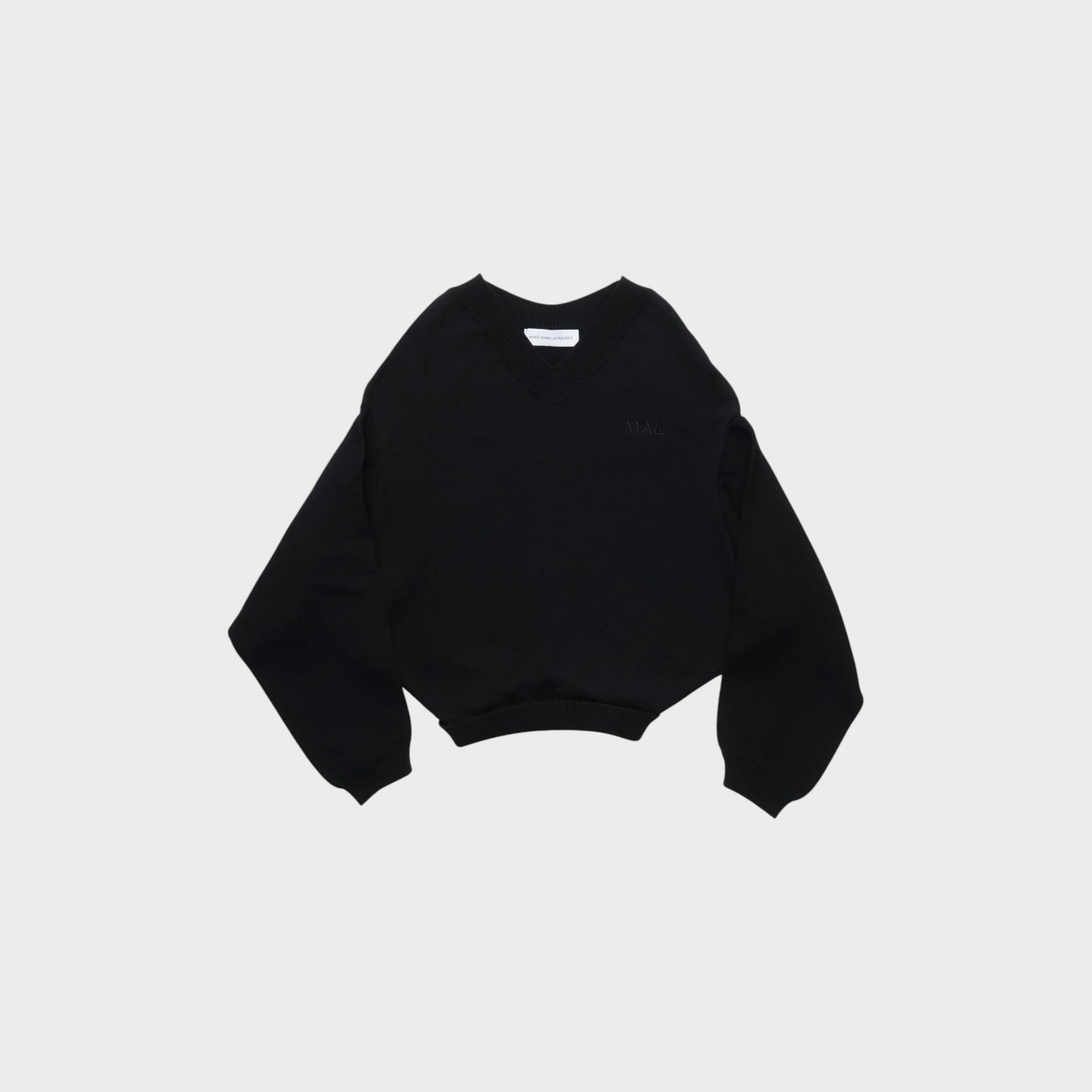 Tasoni Marie Adam-Leenaerdt black v-neck cropped sweater with embroidered logo on chest.