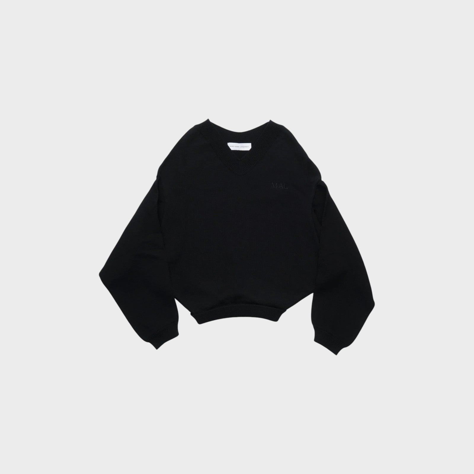 Tasoni Marie Adam-Leenaerdt black v-neck cropped sweater with embroidered logo on chest.