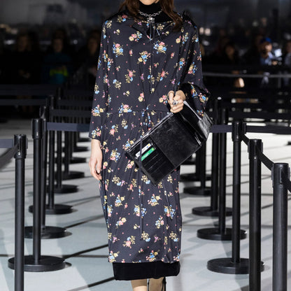 Tasoni Marie Adam-Leenaerdt black floral print long sleeve crew neck midi dress with tie waist.