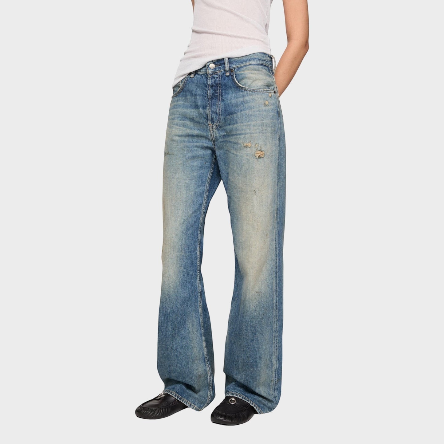 Tasoni mid blue cotton mid waist flare leg denim jeans with distressed details and a worn look.
