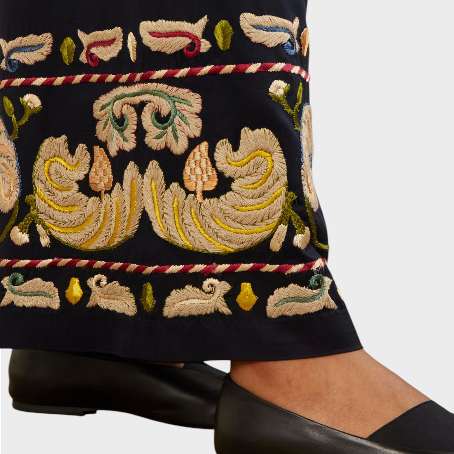 Tasoni navy wide leg trousers with intricate feather embroidery and decorative trim. Black ballet flats worn.