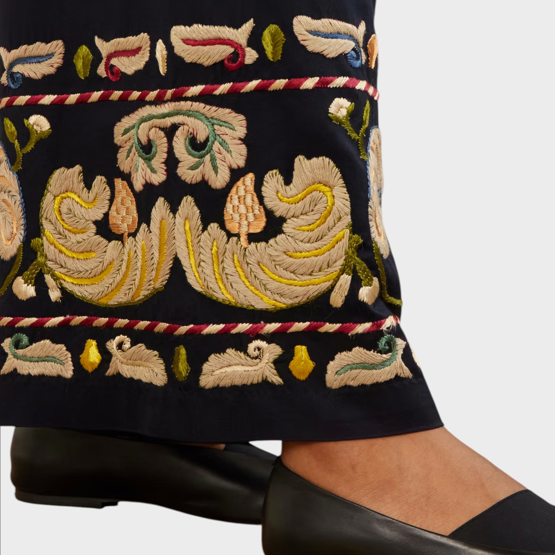 Tasoni navy wide leg trousers with intricate feather embroidery and decorative trim. Black ballet flats worn.