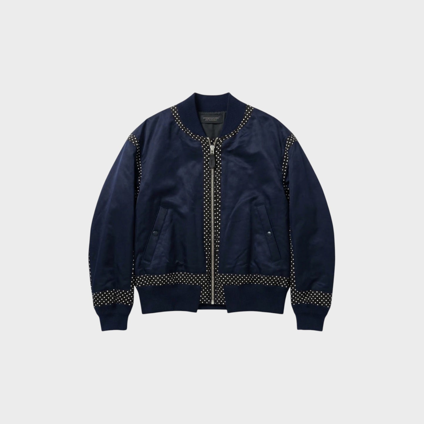 Tasoni navy satin bomber jacket with zip-up front and polka dot trim on collar, cuffs, and hem.