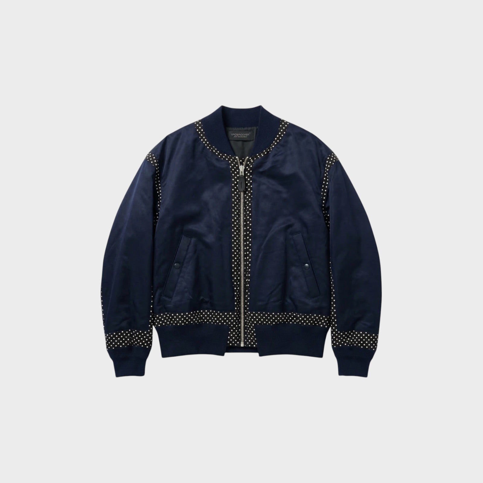 Tasoni navy satin bomber jacket with zip-up front and polka dot trim on collar, cuffs, and hem.