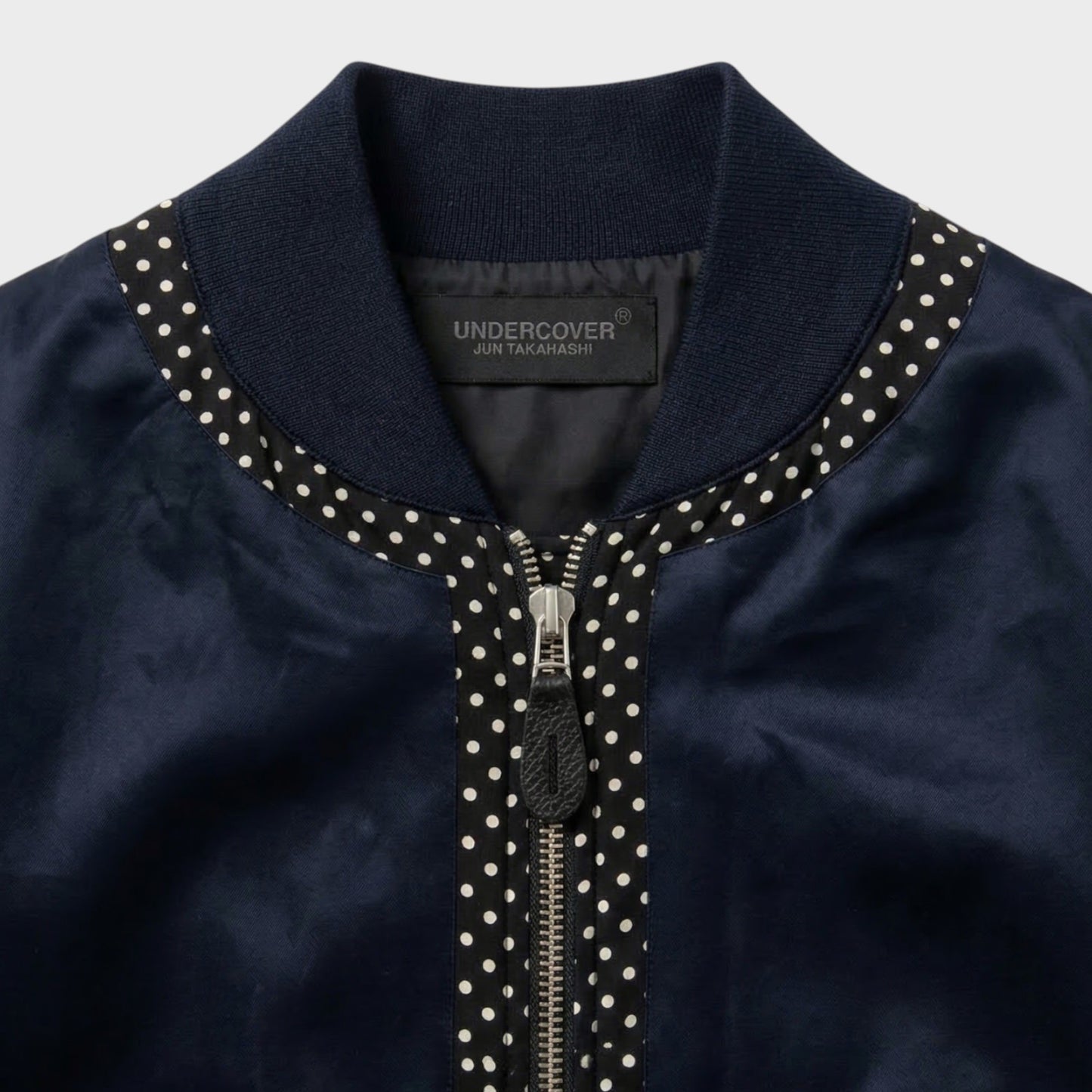 Tasoni navy satin bomber jacket with polka dot trim and zip closure.