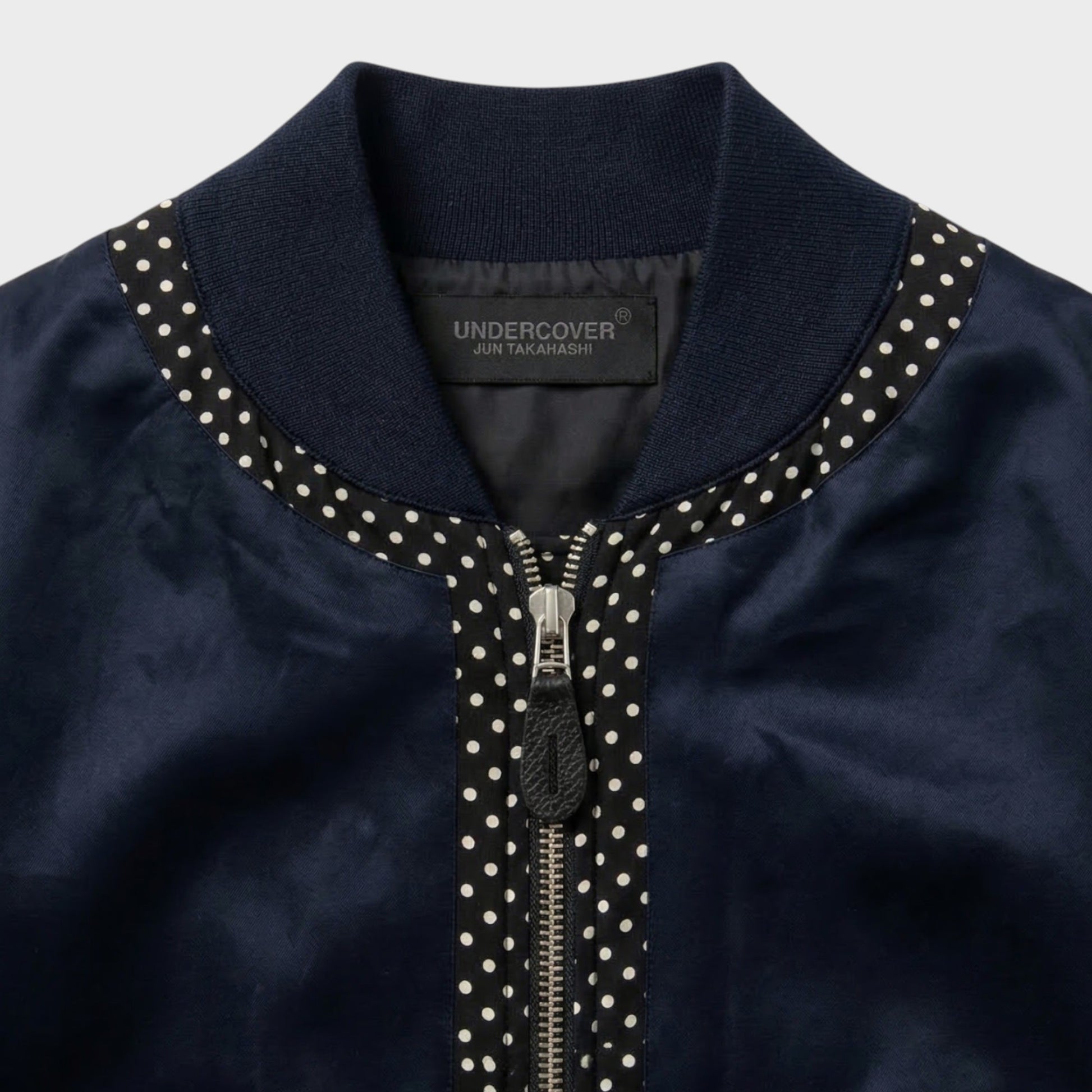 Tasoni navy satin bomber jacket with polka dot trim and zip closure.