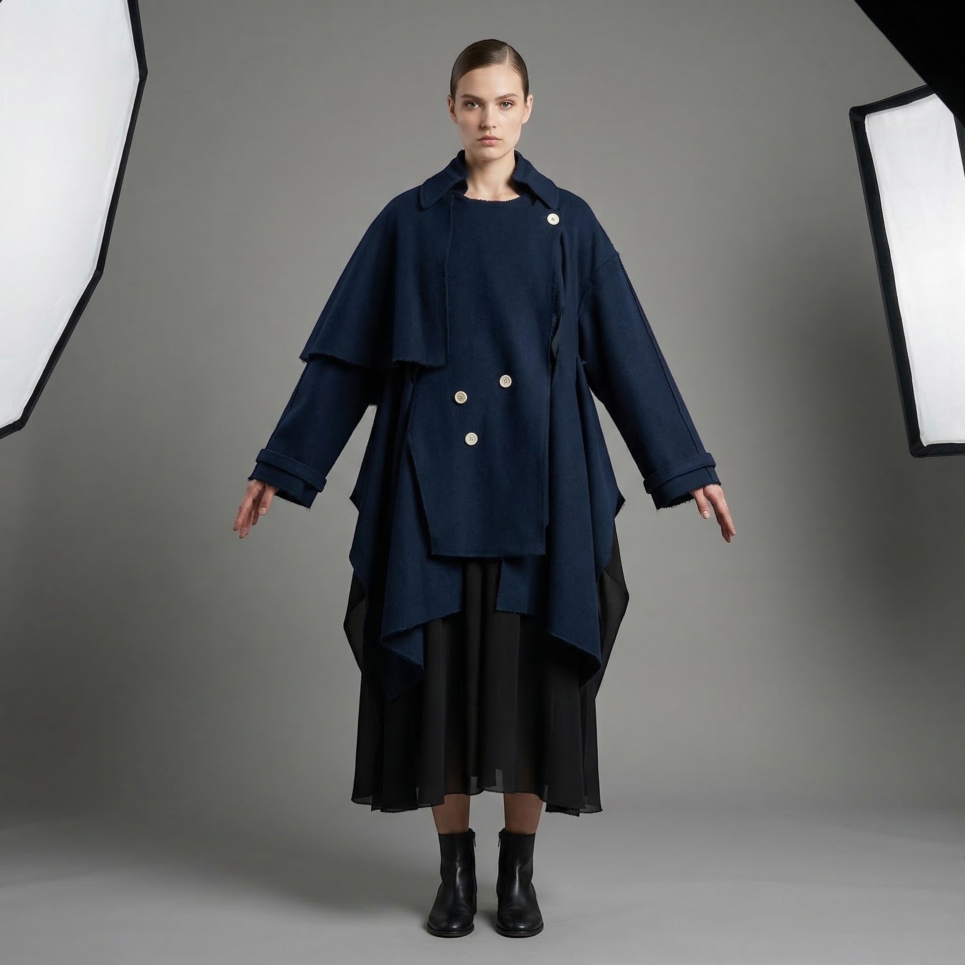 Tasoni navy blue wool coat with ruffled collar, double-breasted closure, and asymmetrical hem.