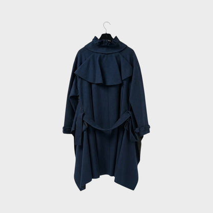 Tasoni navy blue wool coat with ruffled collar and tie waist. Features a dramatic cape-like overlay and cut-out details.