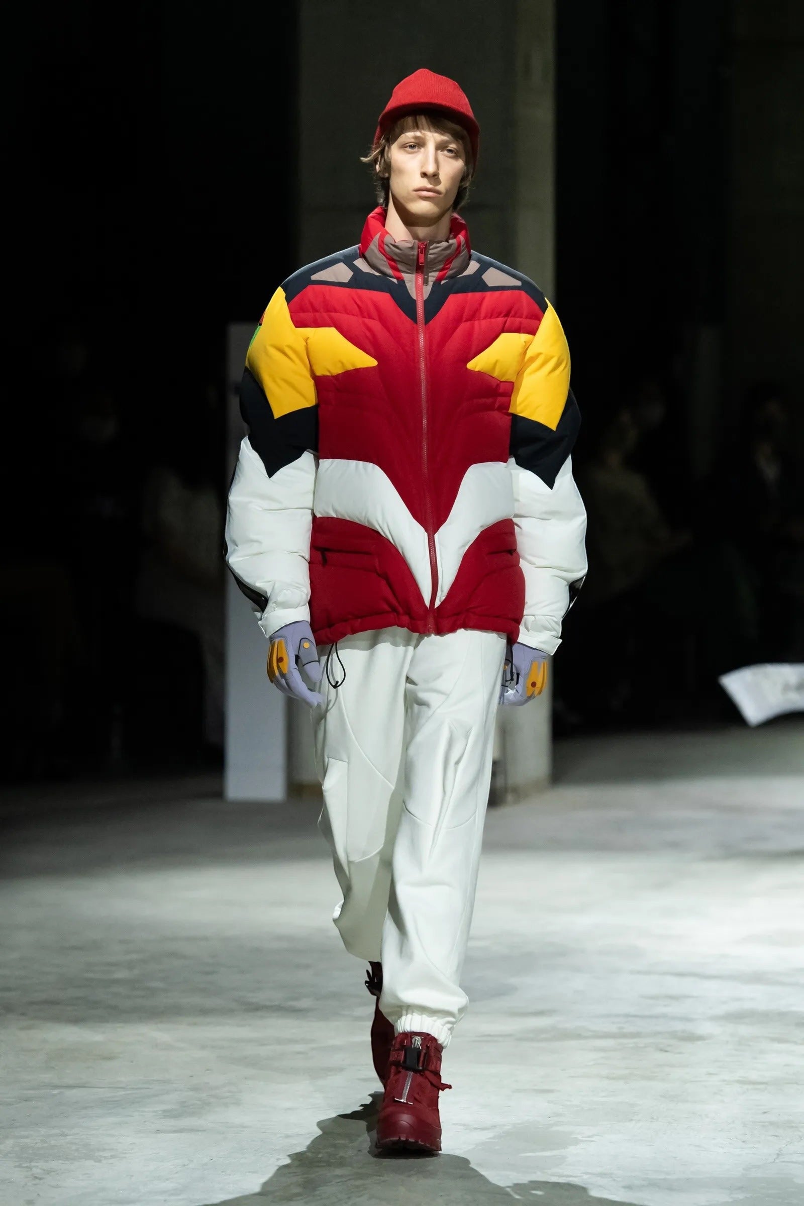 Tasoni Undercover Jacket: Red, yellow, white & black nylon puffer with high neck, zip-up front, and "Neon Genesis Evangelion" patches.
