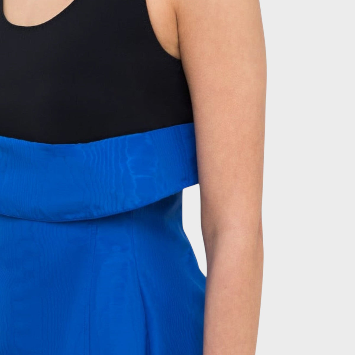 Tasoni Nina Ricci cotton tank top featuring a black scoop neck bodice and a vibrant blue structured waist detail.
