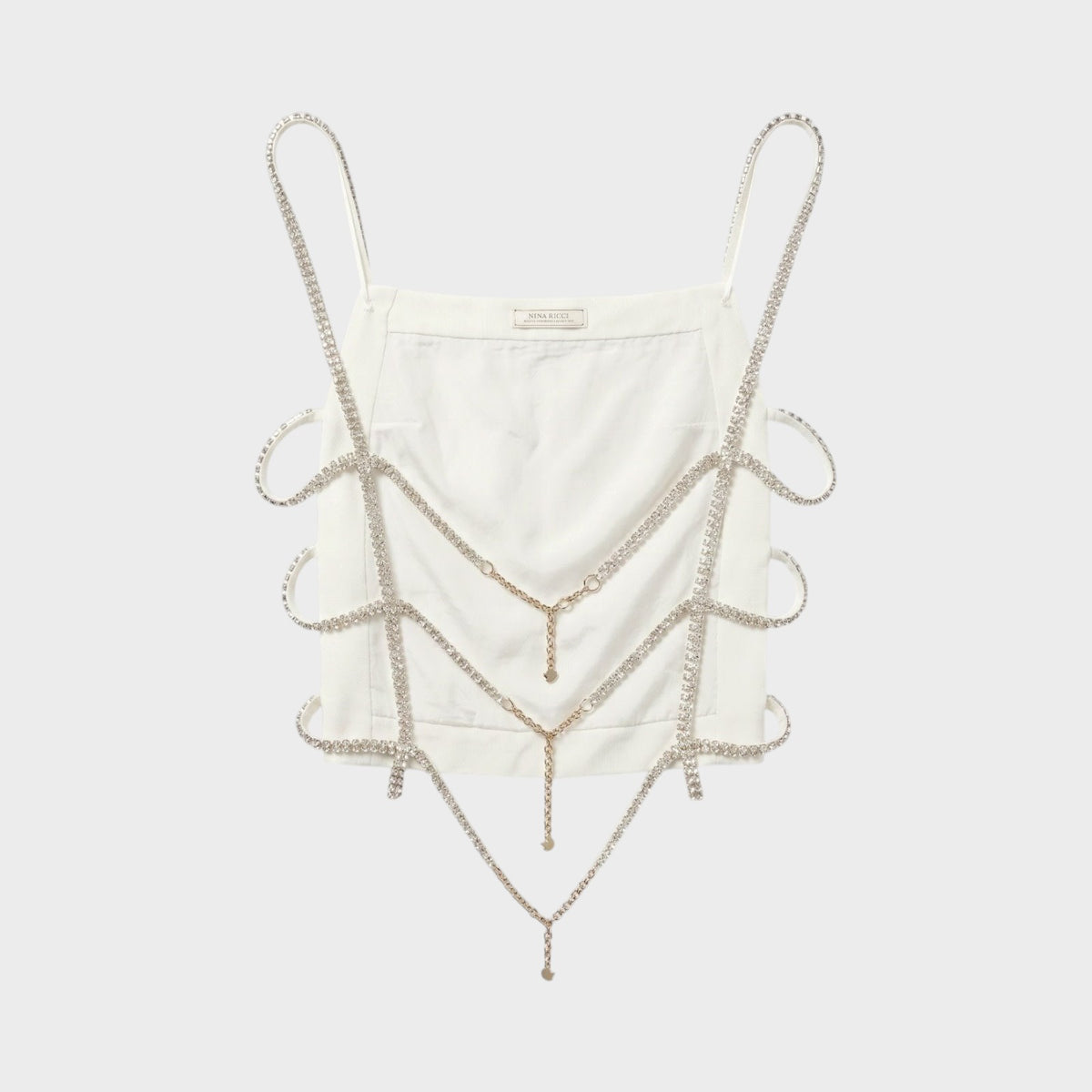 Tasoni Nina Ricci white crop top featuring intricate draped crystal chain embellishments and thin shoulder straps.