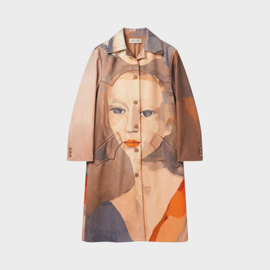 Tasoni Nina Ricci long coat featuring an artistic abstract face print in warm earth tones with a button-up front.