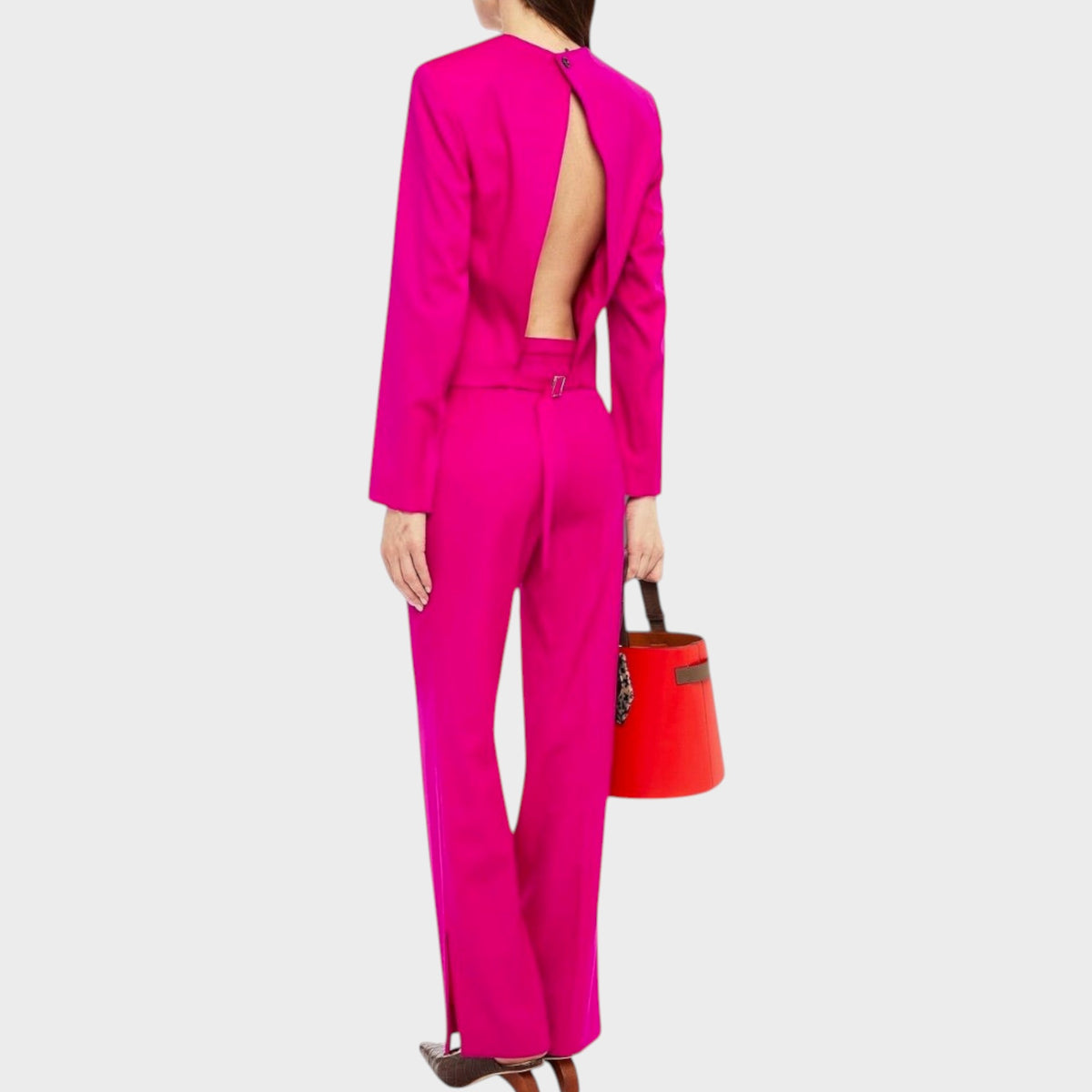 Tasoni Nina Ricci fuchsia wool gabardine trousers worn with a matching open-back blazer and red bucket bag