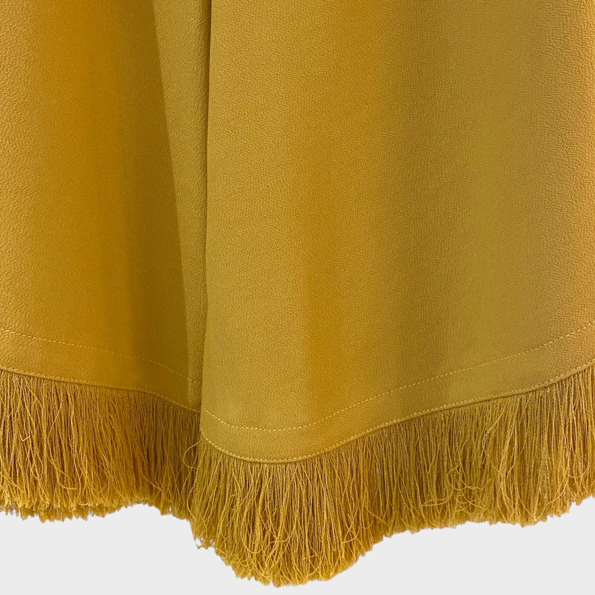 Tasoni Nina Ricci Miel skirt featuring a mustard yellow hue and detailed fringe hemline.