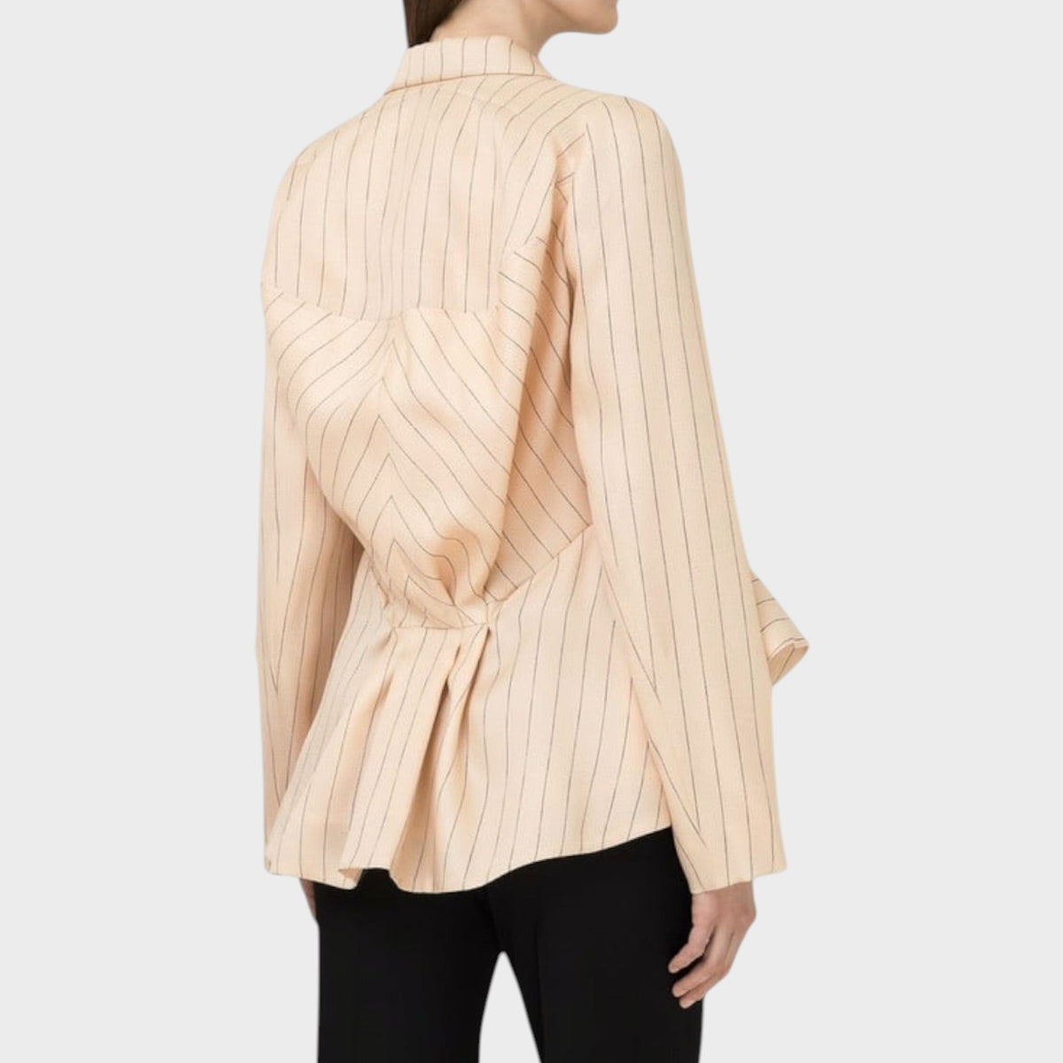 Back view of Tasoni Nina Ricci Natté pleated blazer in beige with thin vertical pinstripes and a cinched waist