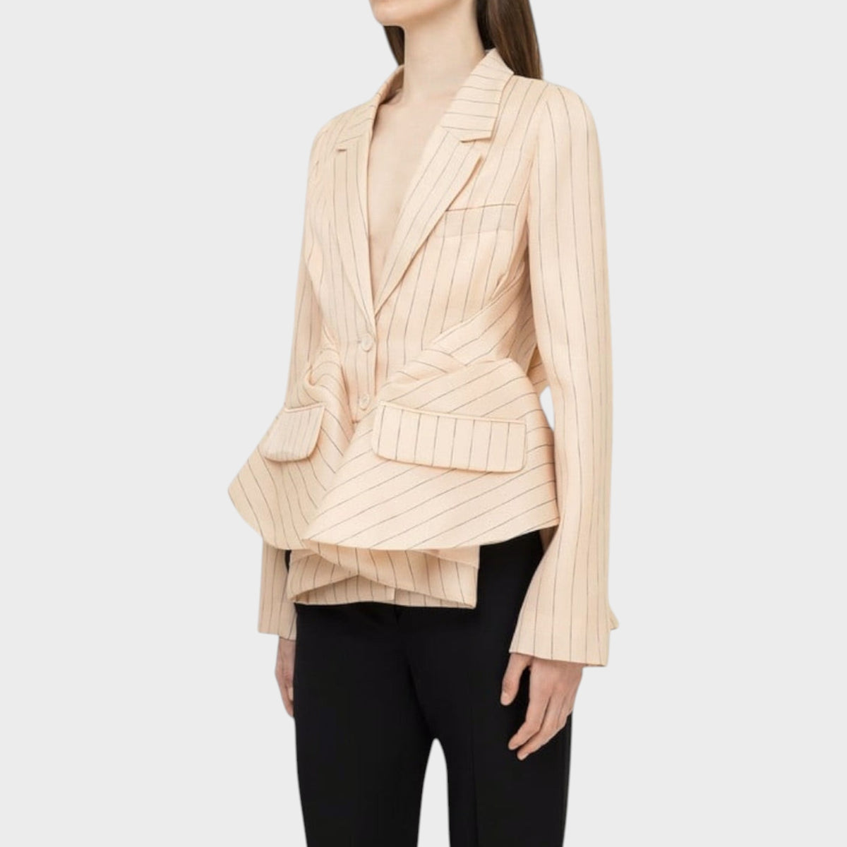 Tasoni Nina Ricci Natté pleated blazer in beige with vertical pinstripes and a structured peplum waist.