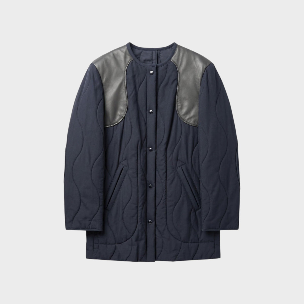 Tasoni Nina Ricci navy blue quilted coat with grey leather shoulder panels and snap button closure.