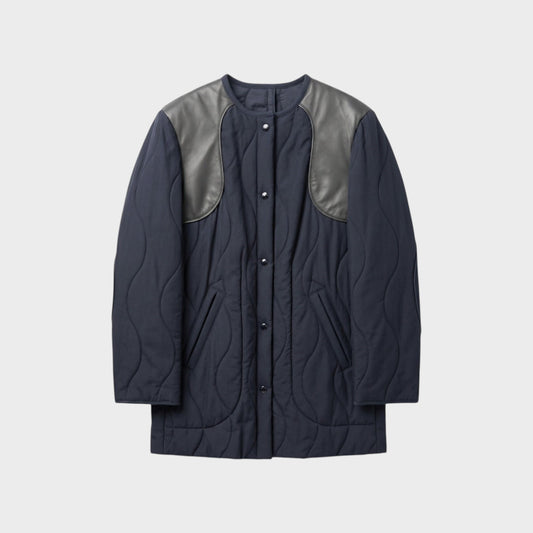 Tasoni Nina Ricci navy blue quilted coat with grey leather shoulder panels and snap button closure.