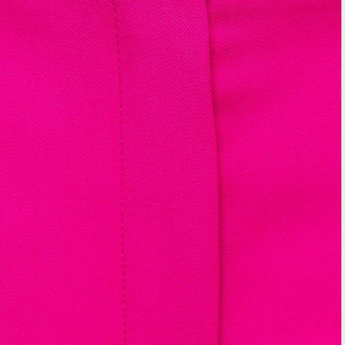Close-up of Tasoni Nina Ricci hot pink wool gabardine trousers showing the fine twill texture and tailored seam.