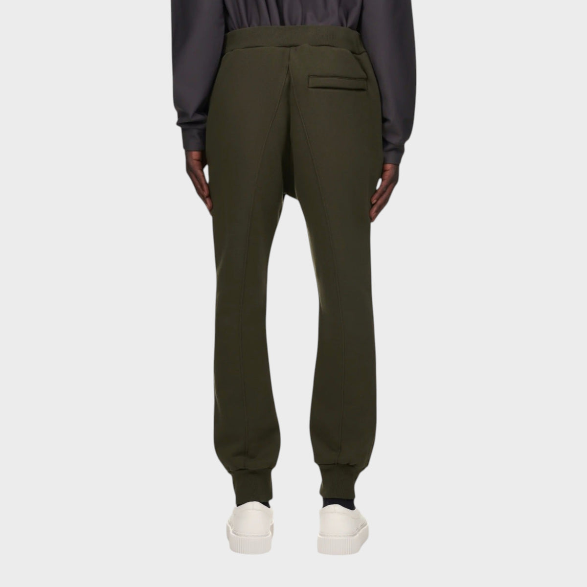 Tasoni olive green cotton sweatpants with elastic waist and back pocket detail. Model wears white sneakers.