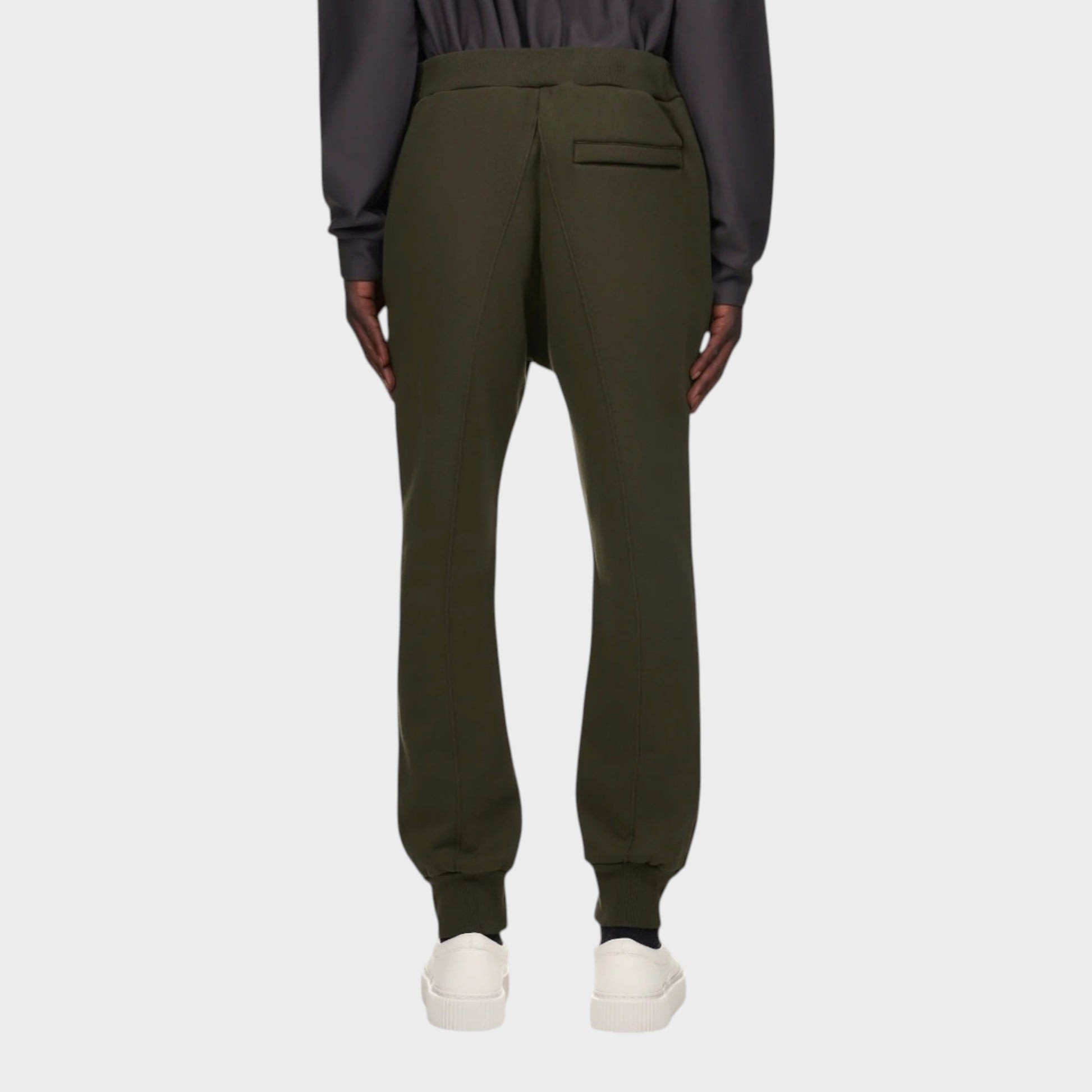 Tasoni olive green cotton sweatpants with elastic waist and back pocket detail. Model wears white sneakers.