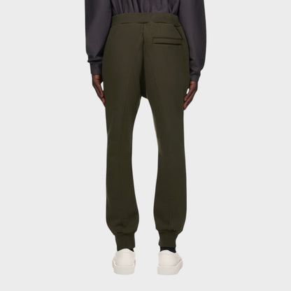 Tasoni olive green cotton sweatpants with elastic waist and back pocket detail. Model wears white sneakers.
