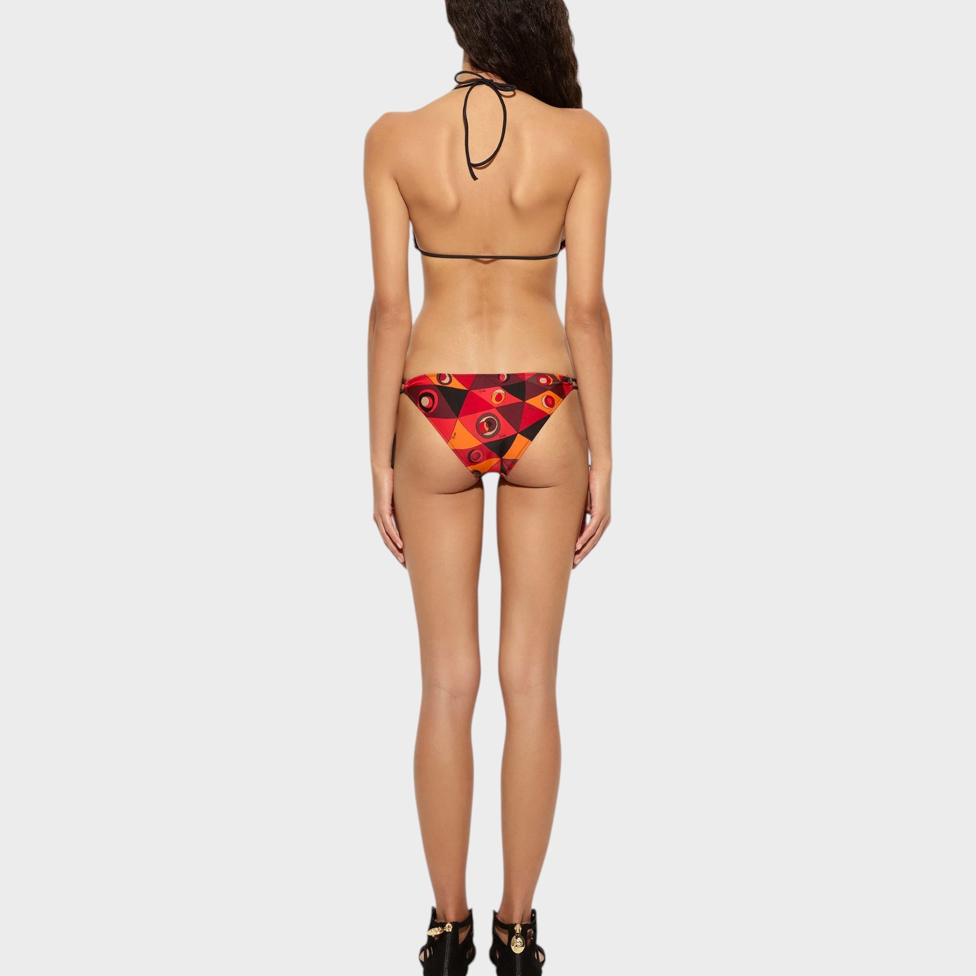 Tasoni bikini bottom in orange, black, and red with a geometric and eye print. Low-rise fit.