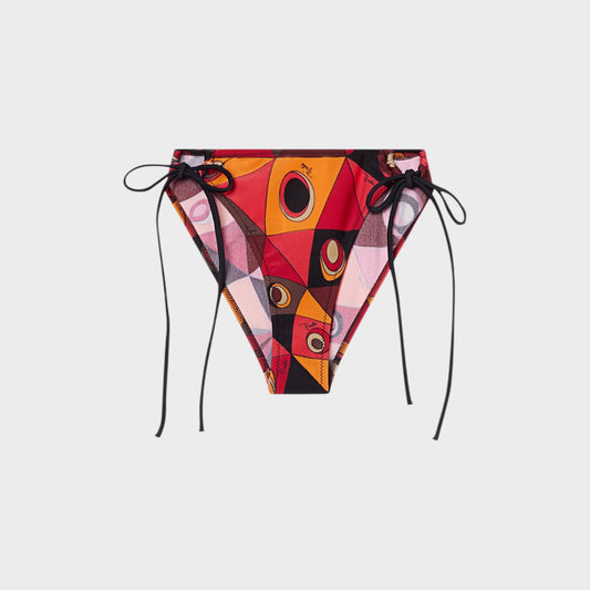 Tasoni bikini bottom with orange, black, and red geometric print and eye motifs. Features black side ties.