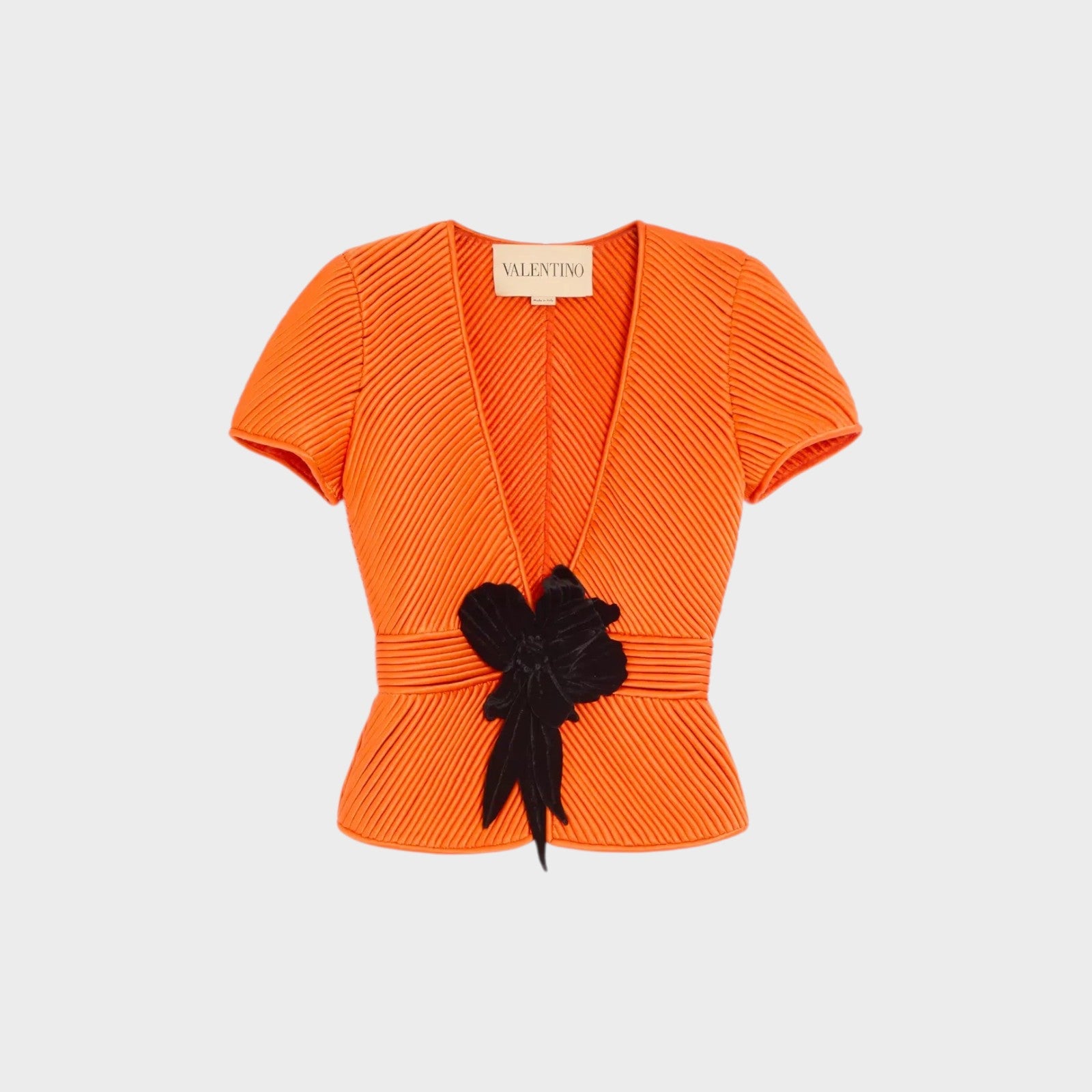 Tasoni orange ribbed short sleeve V-neck jacket with black floral detail and cinched waist.