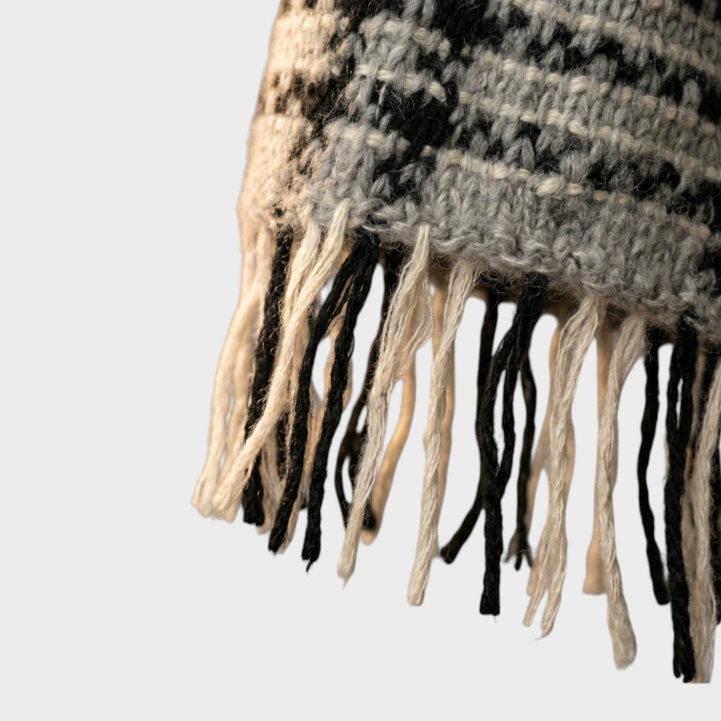 Tasoni oversized mohair and wool check scarf in grey, black, and cream with fringed edges.